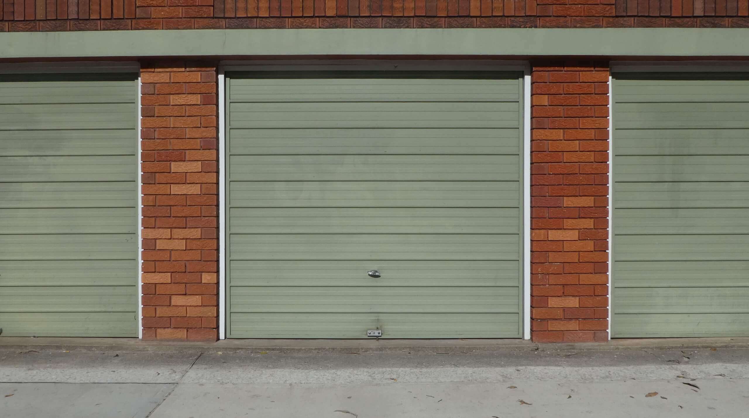 green garage doors on brick frame street view 2022 11 09 04 51 55 utc 1 2